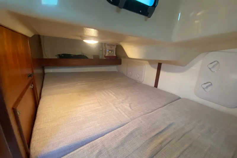 Slide: The Image of Cozy cabin interior of 1995 Hunter 33.5 sailboat with bed and wooden storage. - 28