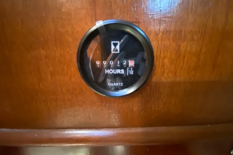 Slide: The Image of Hour meter on 1995 Hunter 33.5 yacht, displaying engine hours on wooden panel. - 31