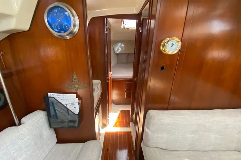 Slide: The Image of Interior of a 1995 Hunter 33.5 sailboat with wood paneling and cozy seating. - 33