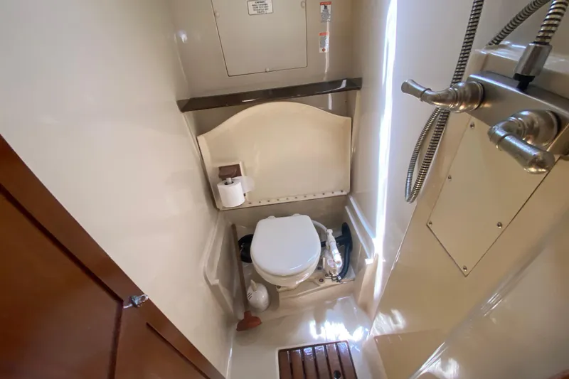 Slide: The Image of Compact bathroom in a 1995 Hunter 33.5 sailboat with toilet and shower fixtures. - 35
