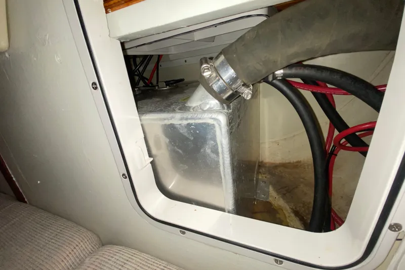 Slide: The Image of Interior view of a 1995 Hunter 33.5 sailboat showing a metal tank and hoses. - 40