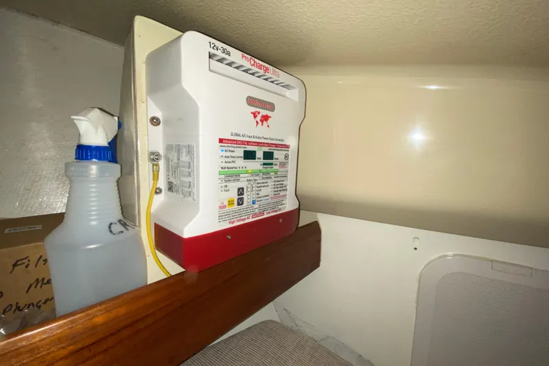 Slide: The Image of Battery charger in a 1995 Hunter 33.5 sailboat interior, with cleaning spray bottle nearby. - 42