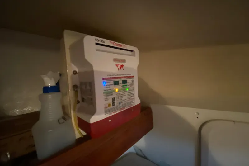 Slide: The Image of Battery charger and spray bottle inside a 1995 Hunter 33.5 boat cabin. - 43