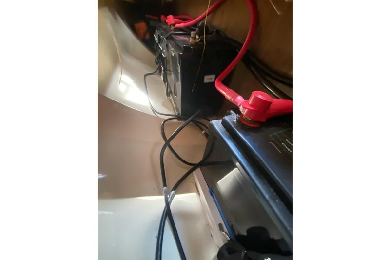Slide: The Image of Battery compartment of a 1995 Hunter 33.5 sailboat with visible wiring. - 47