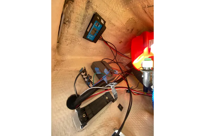 Slide: The Image of Electrical wiring and components inside a 1995 Hunter 33.5 boat, featuring a red fuel container. - 49