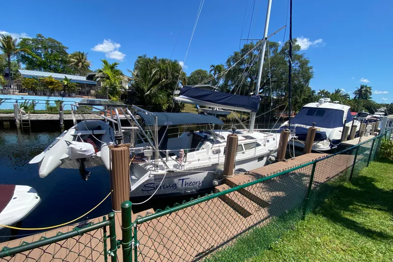 Slide: The Image of Hunter 33.5 sailboat docked at marina, sunny day, lush greenery, 1995 model. - 5