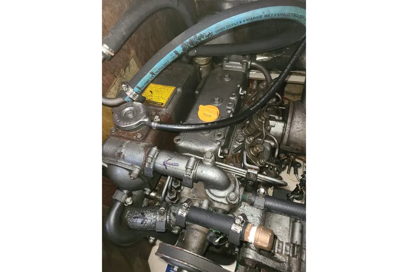 Slide: The Image of Engine of a 1995 Hunter 33.5 sailboat with visible hoses and components. - 52
