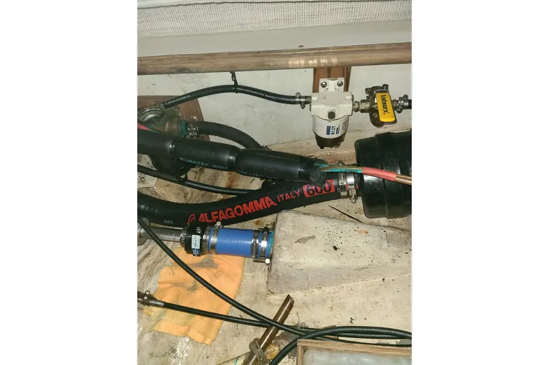 Slide: The Image of Engine compartment of a 1995 Hunter 33.5 sailboat with hoses and fittings. - 53