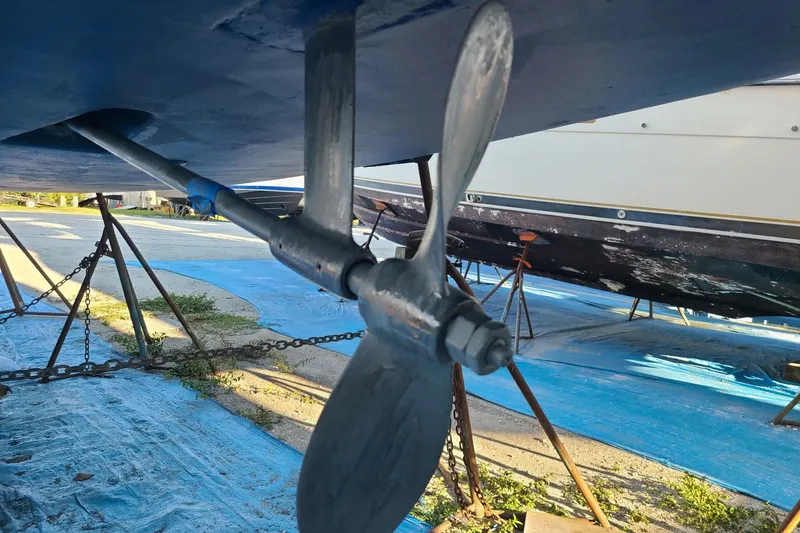 Slide: The Image of Propeller of a 1995 Hunter 33.5 sailboat on dry dock, with blue tarp underneath. - 56