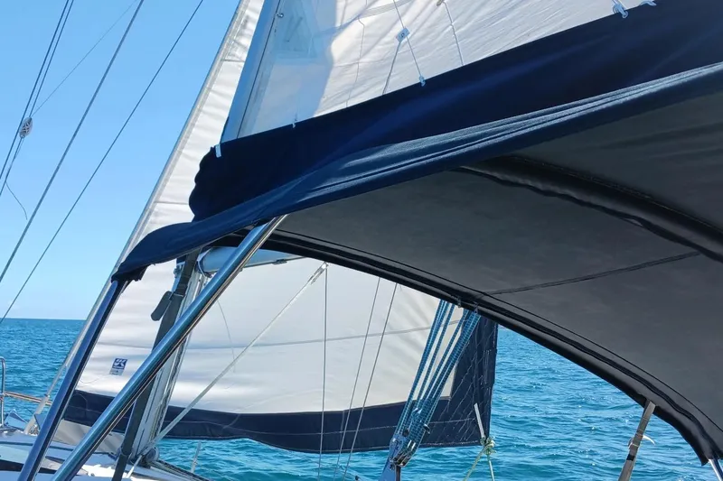 Slide: The Image of Sailing on a 1995 Hunter 33.5 yacht with white sails against a clear blue sea. - 58