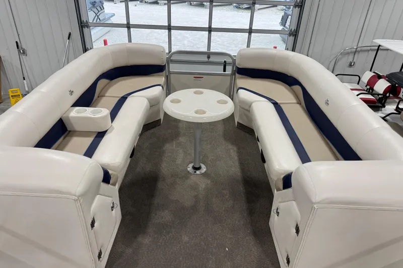 Slide: The Image of Luxurious 2006 G3 boat interior with white and blue seating, cup holders, and table. - 10