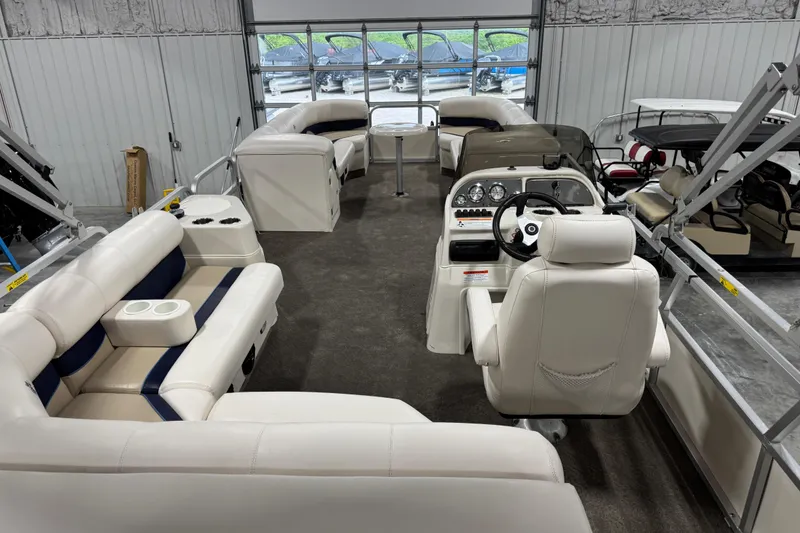 Slide: The Image of Interior of a 2006 G3 pontoon boat with white seating and steering console. - 8