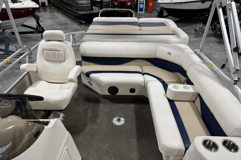 Slide: The Image of Interior of a 2006 G3 boat with white and blue seating, cup holders, and steering console. - 9