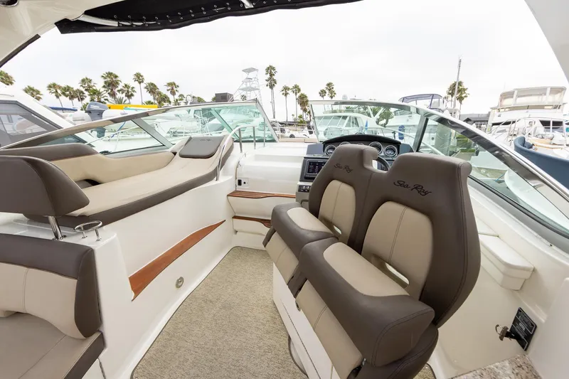 Slide: The Image of Interior of 2015 Sea Ray Sundancer 350 boat with plush seating and modern dashboard. - 10