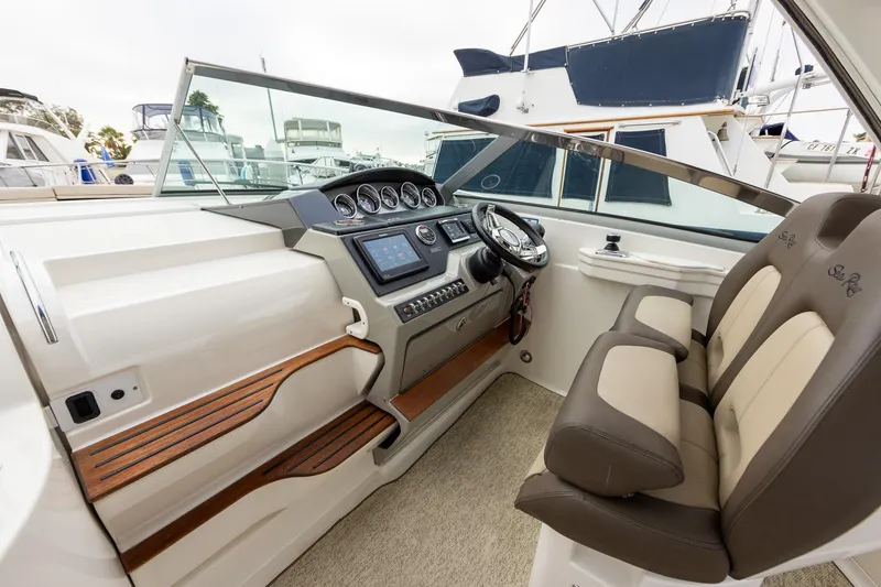 Slide: The Image of Helm of 2015 Sea Ray Sundancer 350 with modern controls and comfortable seating. - 11