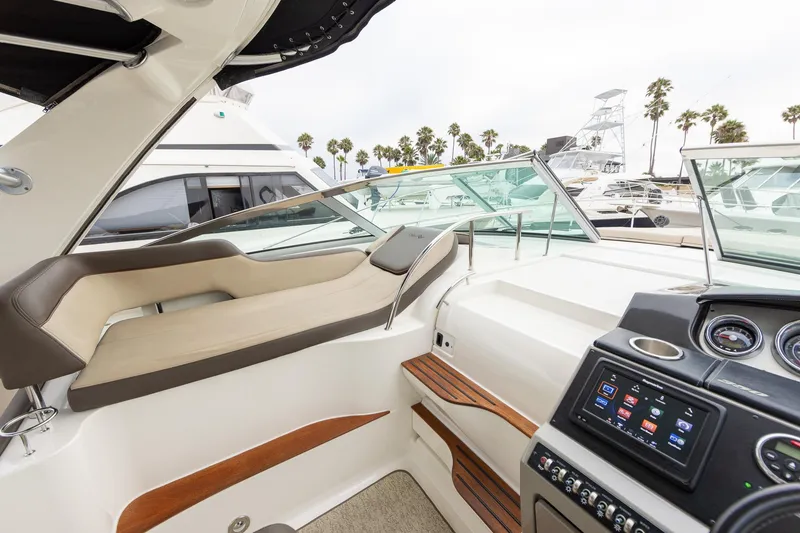 Slide: The Image of Interior view of 2015 Sea Ray Sundancer 350 yacht with luxurious seating and modern dashboard. - 12