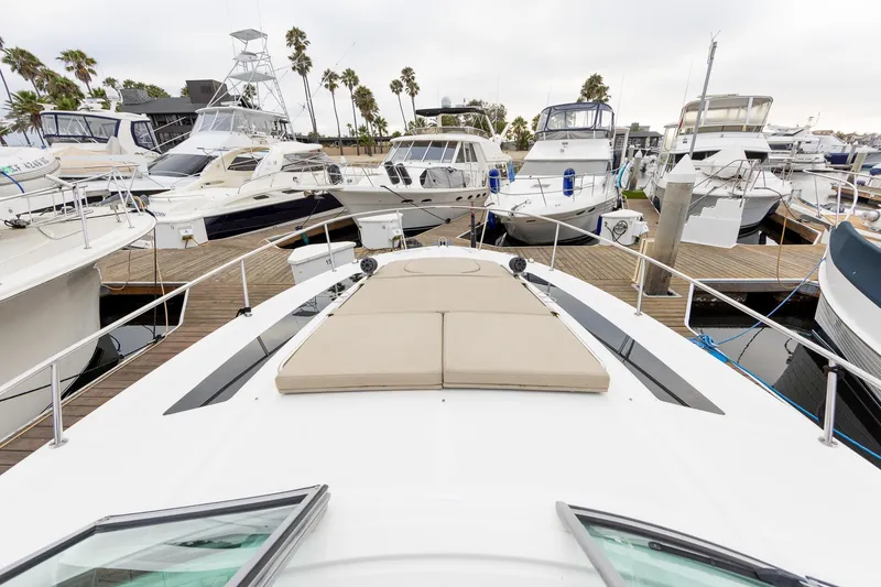 Slide: The Image of 2015 Sea Ray Sundancer 350 yacht docked among other boats at a marina. - 13