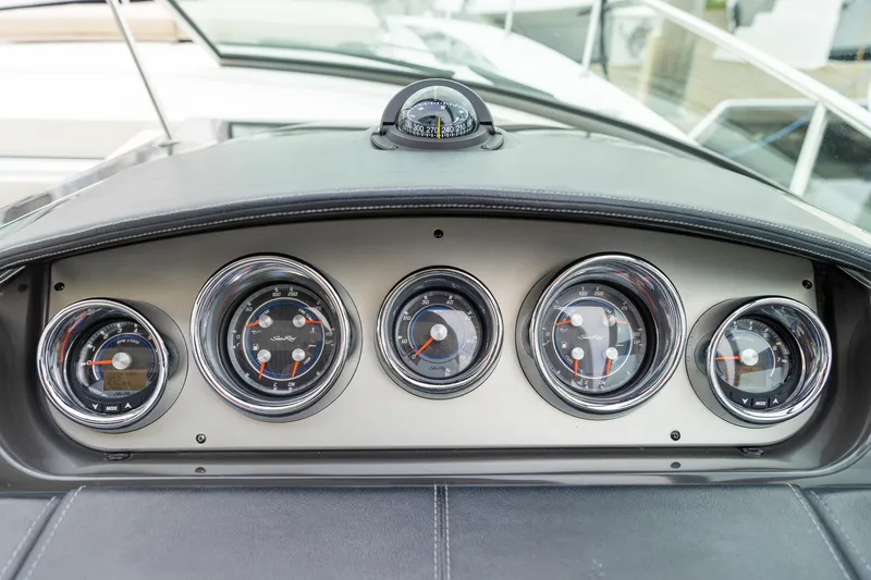 Slide: The Image of Dashboard of 2015 Sea Ray Sundancer 350 boat with five circular gauges. - 15