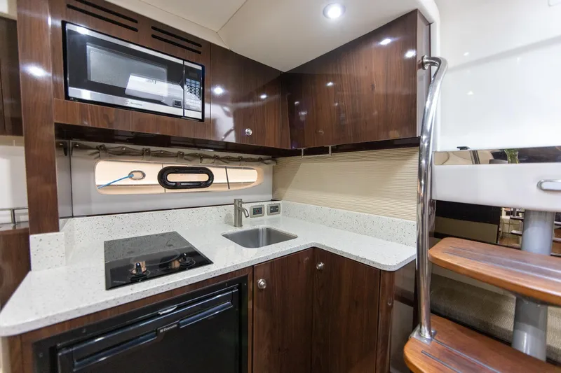 Slide: The Image of Interior of 2015 Sea Ray Sundancer 350 yacht kitchen with modern appliances. - 21