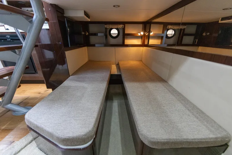 Slide: The Image of Interior cabin of 2015 Sea Ray Sundancer 350 with twin cushioned benches. - 23