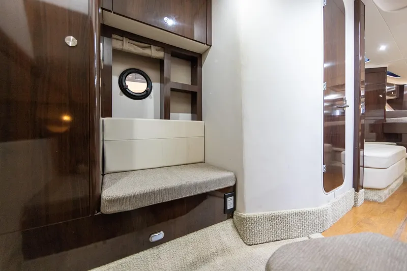 Slide: The Image of Interior of 2015 Sea Ray Sundancer 350 yacht, featuring elegant wood finishes and seating. - 24