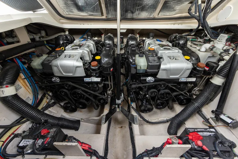 Slide: The Image of Engine compartment of a 2015 Sea Ray Sundancer 350, showcasing dual engines and mechanical components. - 27