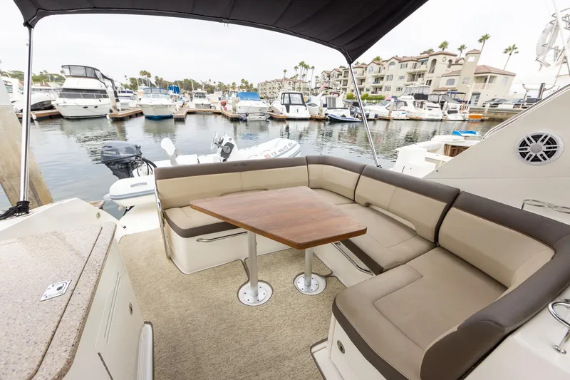Slide: The Image of 2015 Sea Ray Sundancer 350 yacht interior with seating and table at marina. - 6