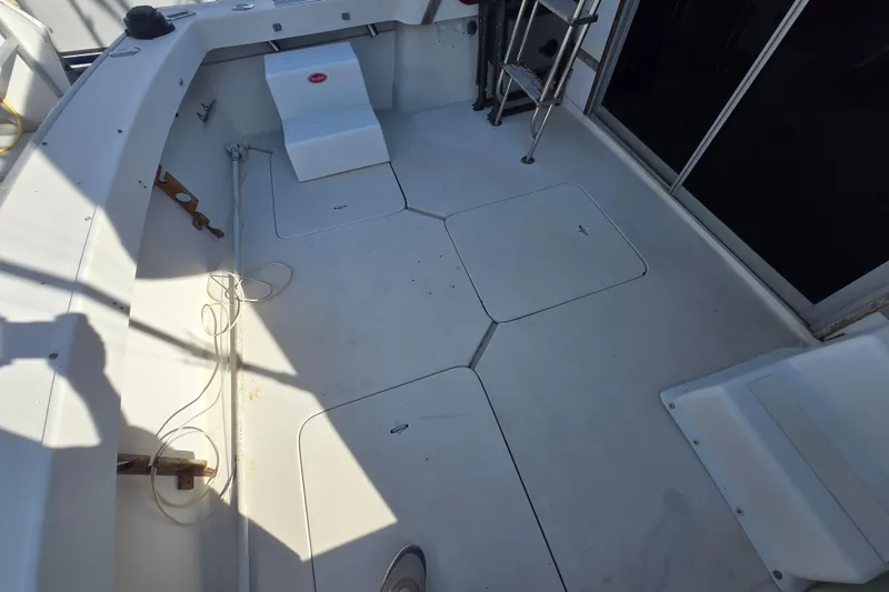 Slide: The Image of 1988 Silverton 34 Convertible boat deck with storage hatches and ladder. - 12