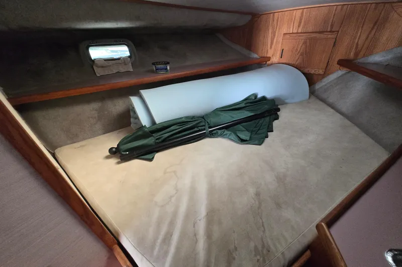 Slide: The Image of Interior cabin of 1988 Silverton 34 Convertible with bed and stored items. - 13