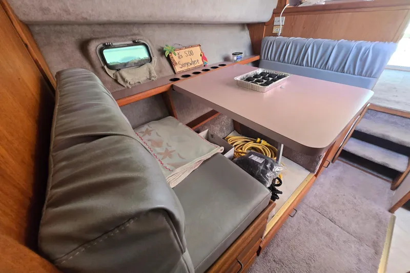 Slide: The Image of Interior of 1988 Silverton 34 Convertible boat with seating and table setup. - 15