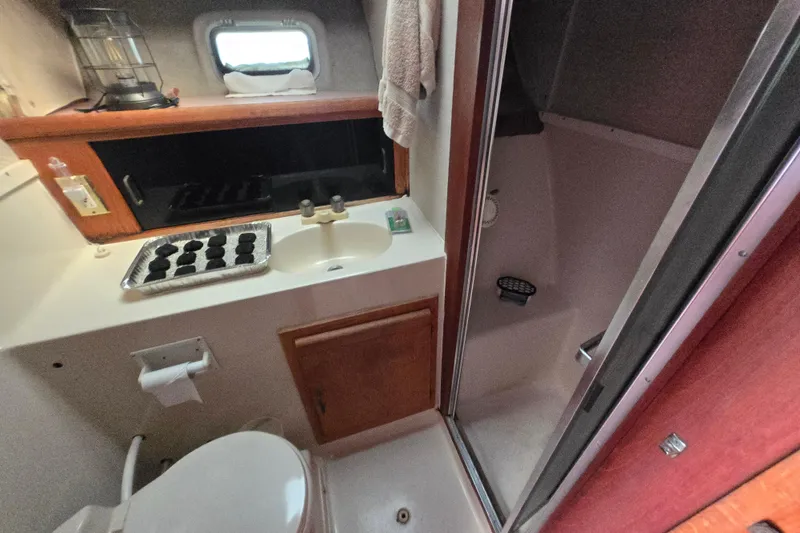 Slide: The Image of Bathroom interior of 1988 Silverton 34 Convertible yacht with sink, shower, and toilet. - 17