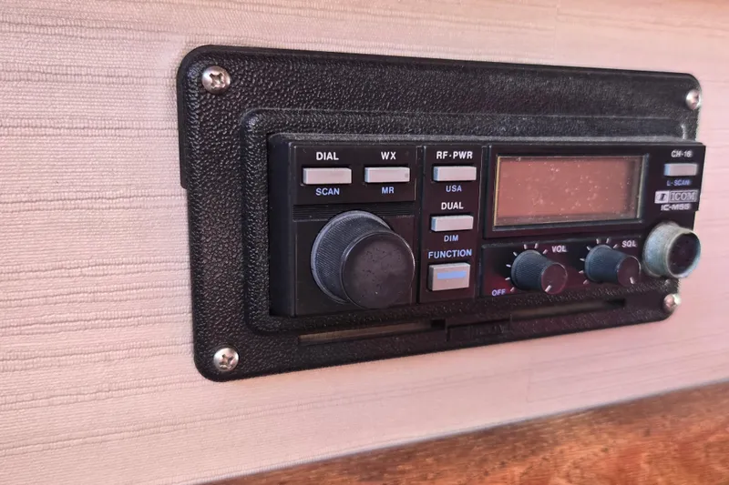 Slide: The Image of 1988 Silverton 34 Convertible boat radio control panel with various knobs and buttons. - 21