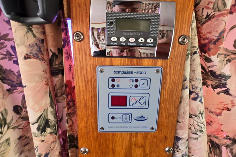 Slide: The Image of Control panel on 1988 Silverton 34 Convertible boat, surrounded by floral curtains. - 22