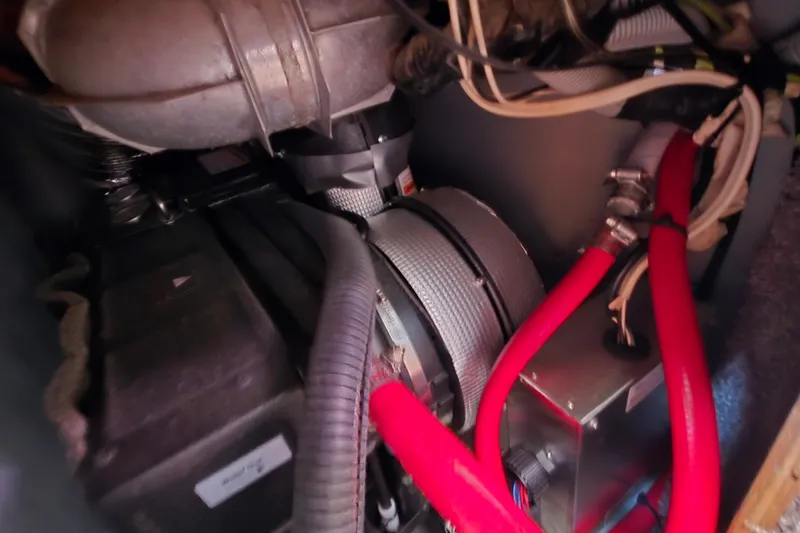 Slide: The Image of Engine compartment of a 1988 Silverton 34 Convertible with visible red hoses and wiring. - 23