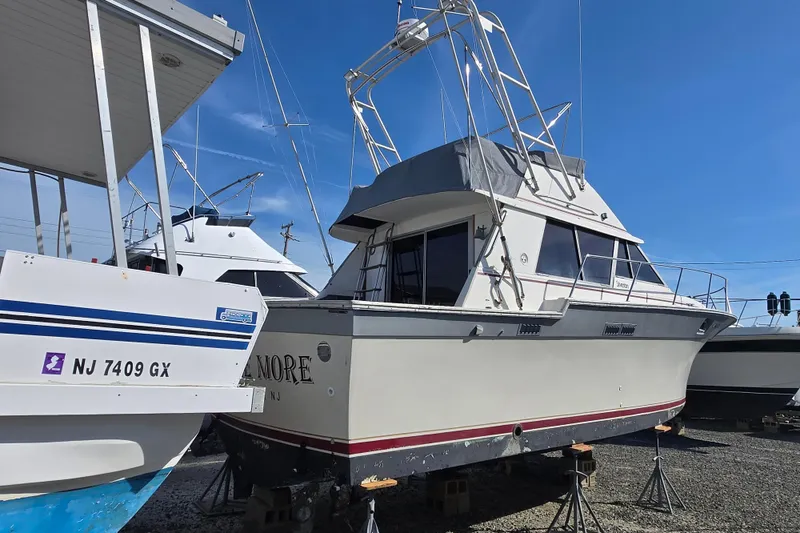 Slide: The Image of 1988 Silverton 34 Convertible boat on dry dock under clear blue sky. - 3