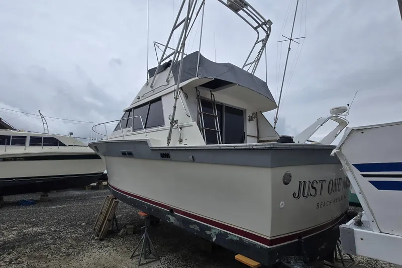 Slide: The Image of 1988 Silverton 34 Convertible boat on dry dock, overcast sky background. - 4