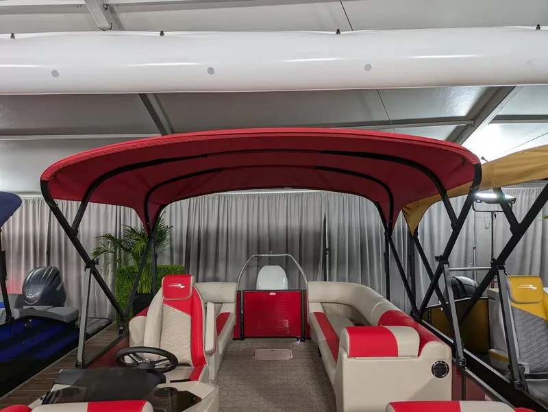 Slide: The Image of Bennington 23 SSR 2027 pontoon boat with red canopy and luxurious interior. - 5