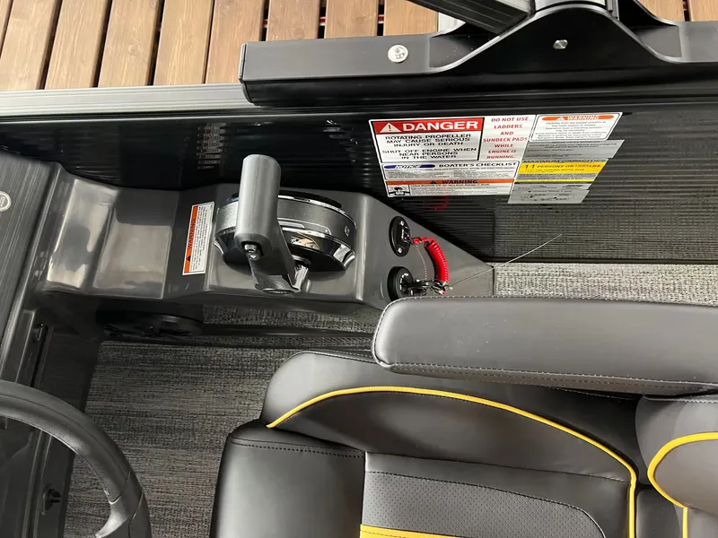 Slide: The Image of Interior of 2027 Bennington 23SL with control console and warning labels. - 8