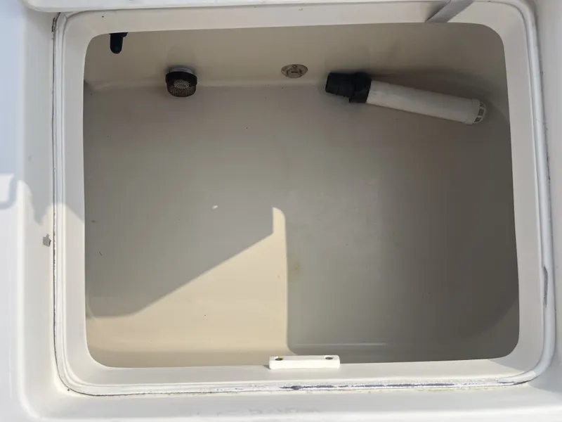 Slide: The Image of Interior of a 2008 Pathfinder 2200 boat, empty storage compartment. - 21