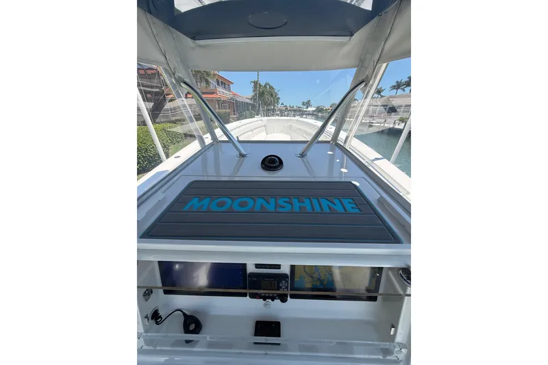 Slide: The Image of 2012 Invincible 42 Open Fisherman boat interior with "Moonshine" label, docked in a marina. - 11