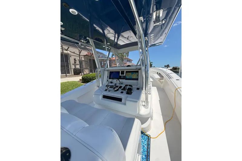 Slide: The Image of 2012 Invincible 42 Open Fisherman boat cockpit with navigation equipment and seating. - 13