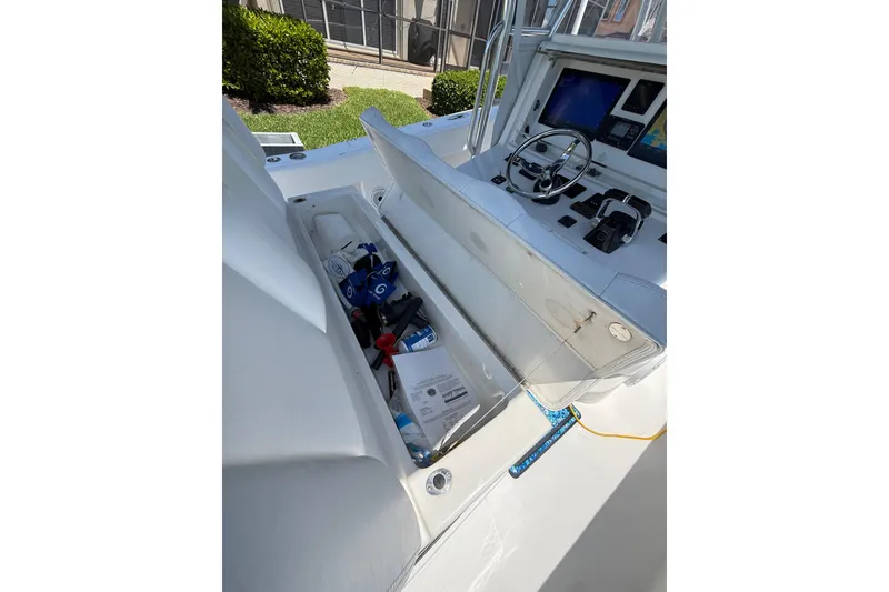 Slide: The Image of 2012 Invincible 42 Open Fisherman boat cockpit with open storage compartment and navigation controls. - 15