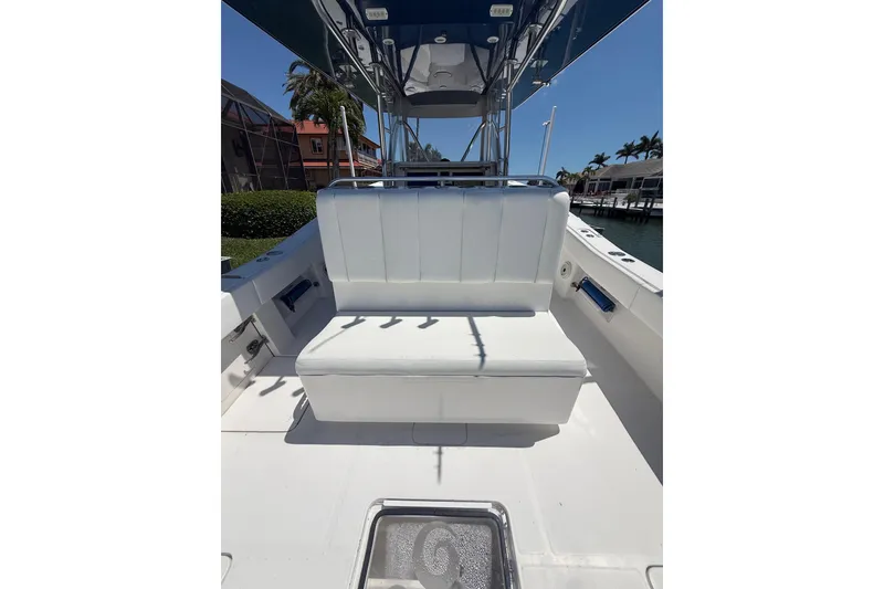 Slide: The Image of 2012 Invincible 42 Open Fisherman boat interior with white seating and canopy. - 16