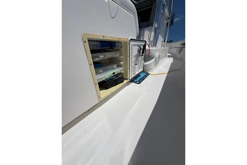 Slide: The Image of Open storage compartment on 2012 Invincible 42 Open Fisherman boat deck. - 18