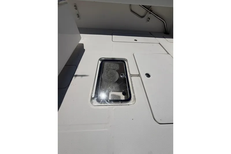 Slide: The Image of 2012 Invincible 42 Open Fisherman deck with storage hatch. - 19