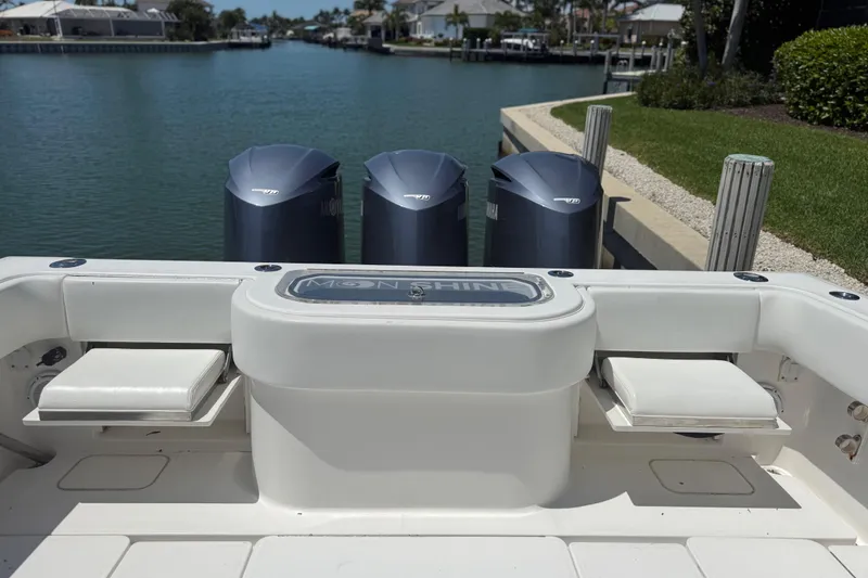 Slide: The Image of 2012 Invincible 42 Open Fisherman boat with triple outboard engines docked by a canal. - 21