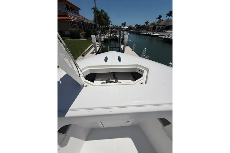 Slide: The Image of 2012 Invincible 42 Open Fisherman boat docked at a marina, sunny day. - 32