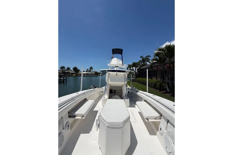 Slide: The Image of 2012 Invincible 42 Open Fisherman boat docked under clear blue sky. - 34