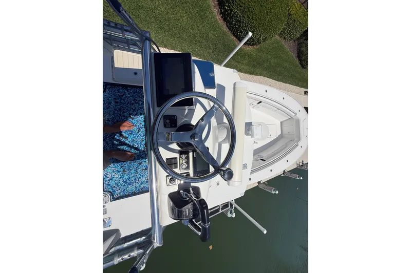 Slide: The Image of 2012 Invincible 42 Open Fisherman boat helm with steering wheel and controls. - 36
