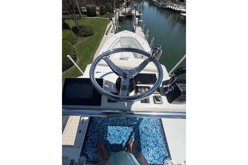 Slide: The Image of Invincible 42 Open Fisherman 2012 helm view with steering wheel and controls. - 37
